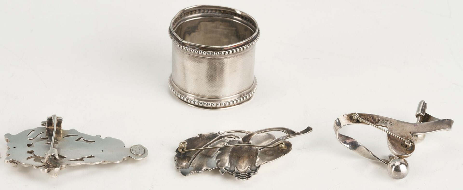 Lot 874: 10 Silver items incl. Tea Caddy, Larding Needles, Cigar Case, Brooches