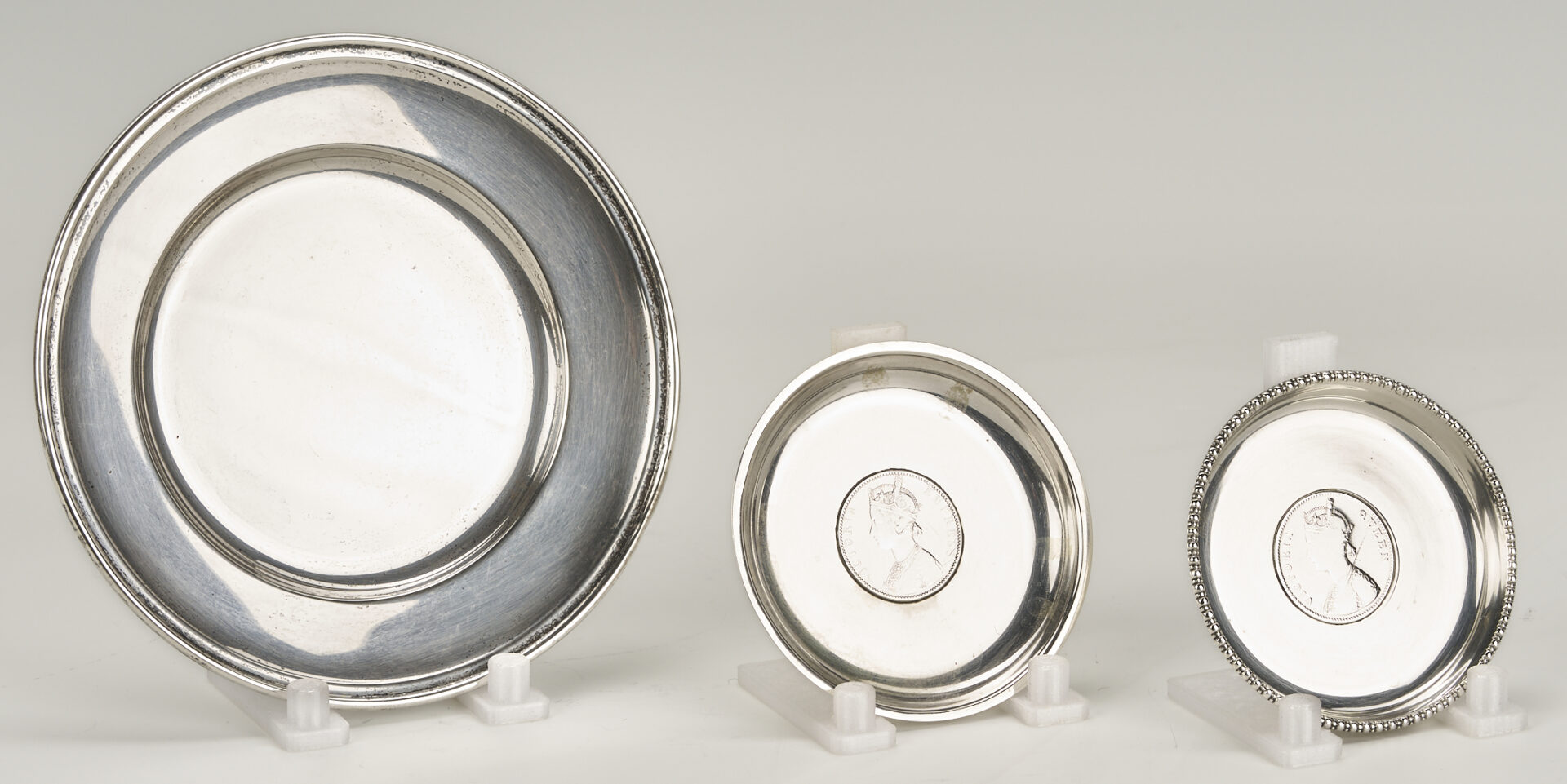Lot 1015: 6 Sterling Silver Bread Plates & 4 Queen Victoria/King George Rupee Silver Coasters