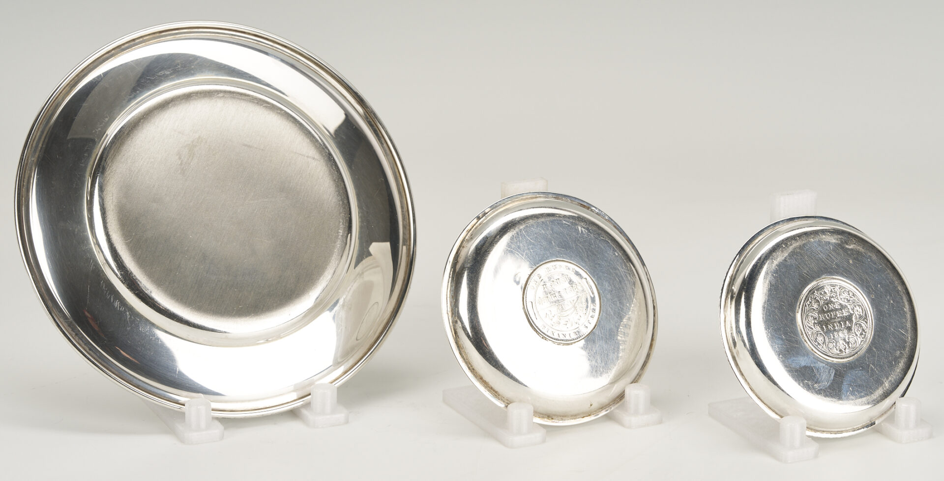 Lot 1015: 6 Sterling Silver Bread Plates & 4 Queen Victoria/King George Rupee Silver Coasters