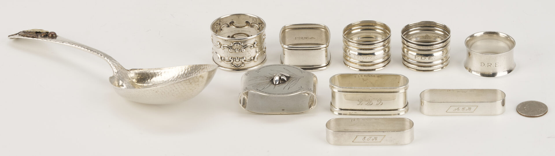 Lot 1202: Gorham Mixed Metal Serving Spoon plus 9 Sterling Napkin Rings