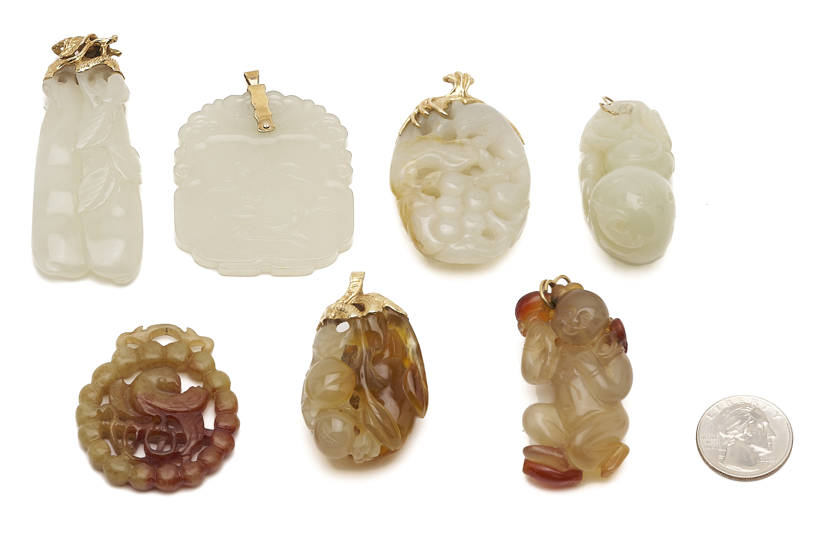 Lot 36: 7 Gold & Carved Nephrite Jade Pendants