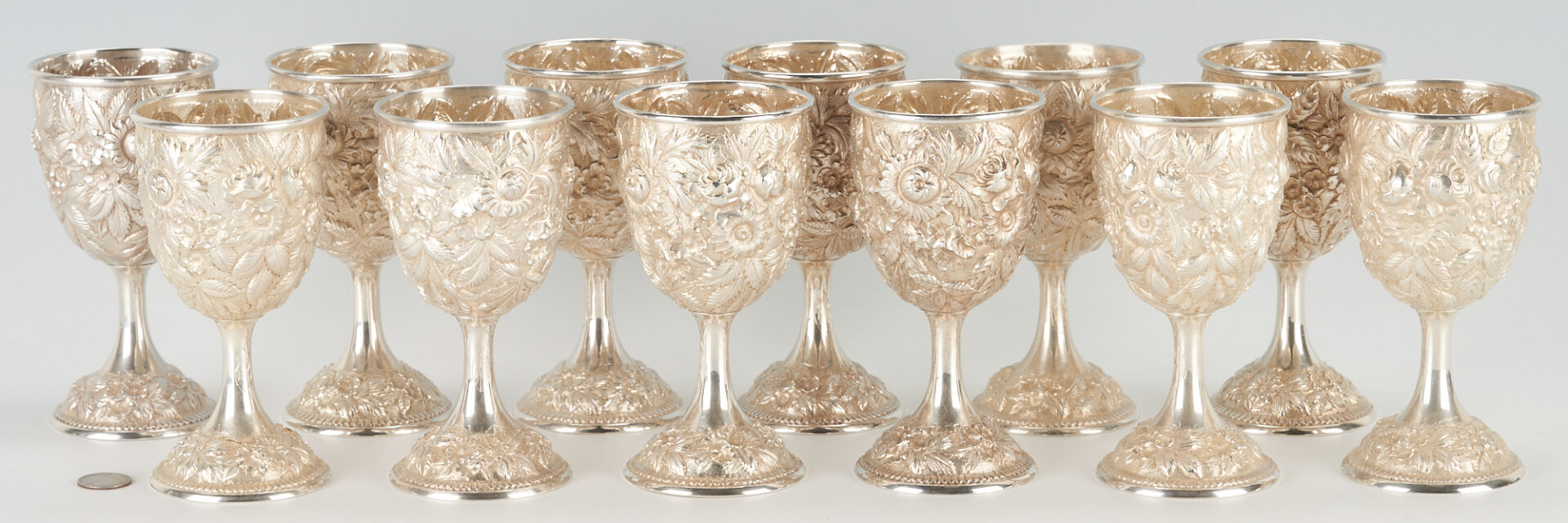 Lot 46: Set of 12 Kirk Repousse Sterling Silver Goblets, Hand Decorated