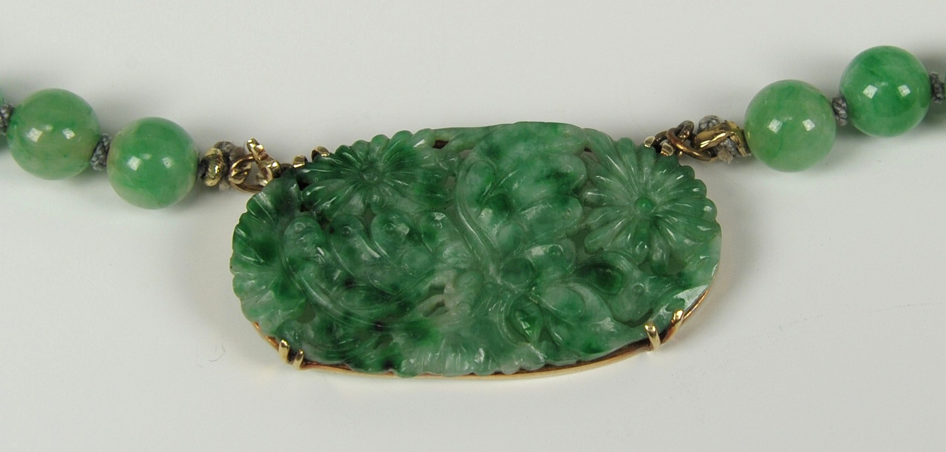 Lot 213: Two Jade and gold necklaces