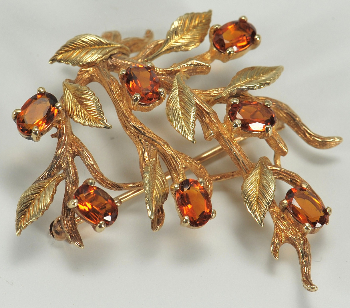 Lot 220: 14K gold branch style brooch with stone flowers