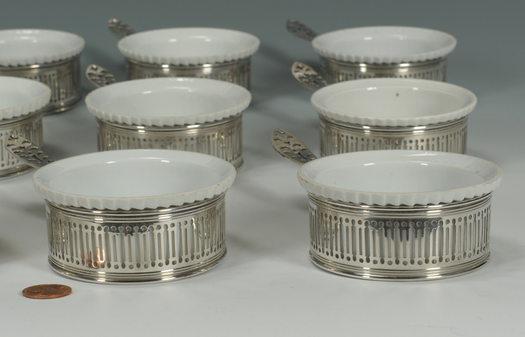 Lot 419: Set of 12 Gorham sterling and porcelain ramekins