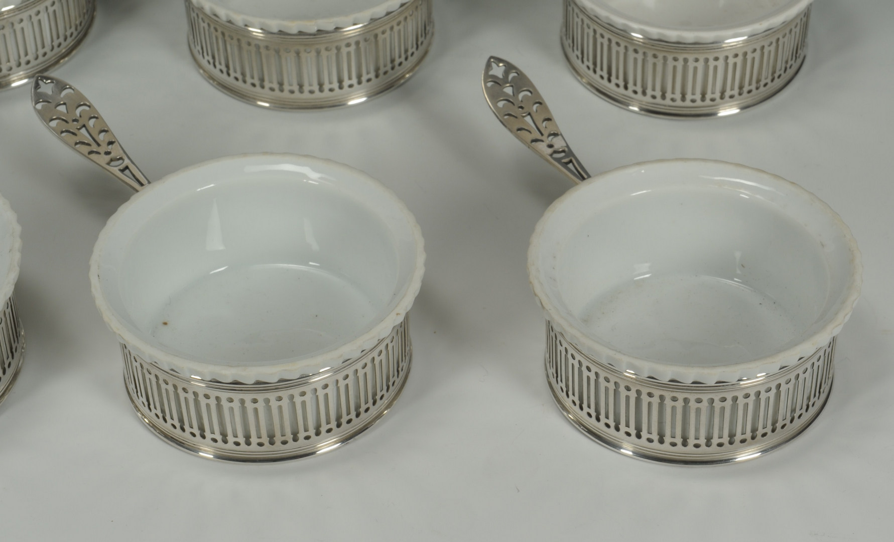 Lot 419: Set of 12 Gorham sterling and porcelain ramekins