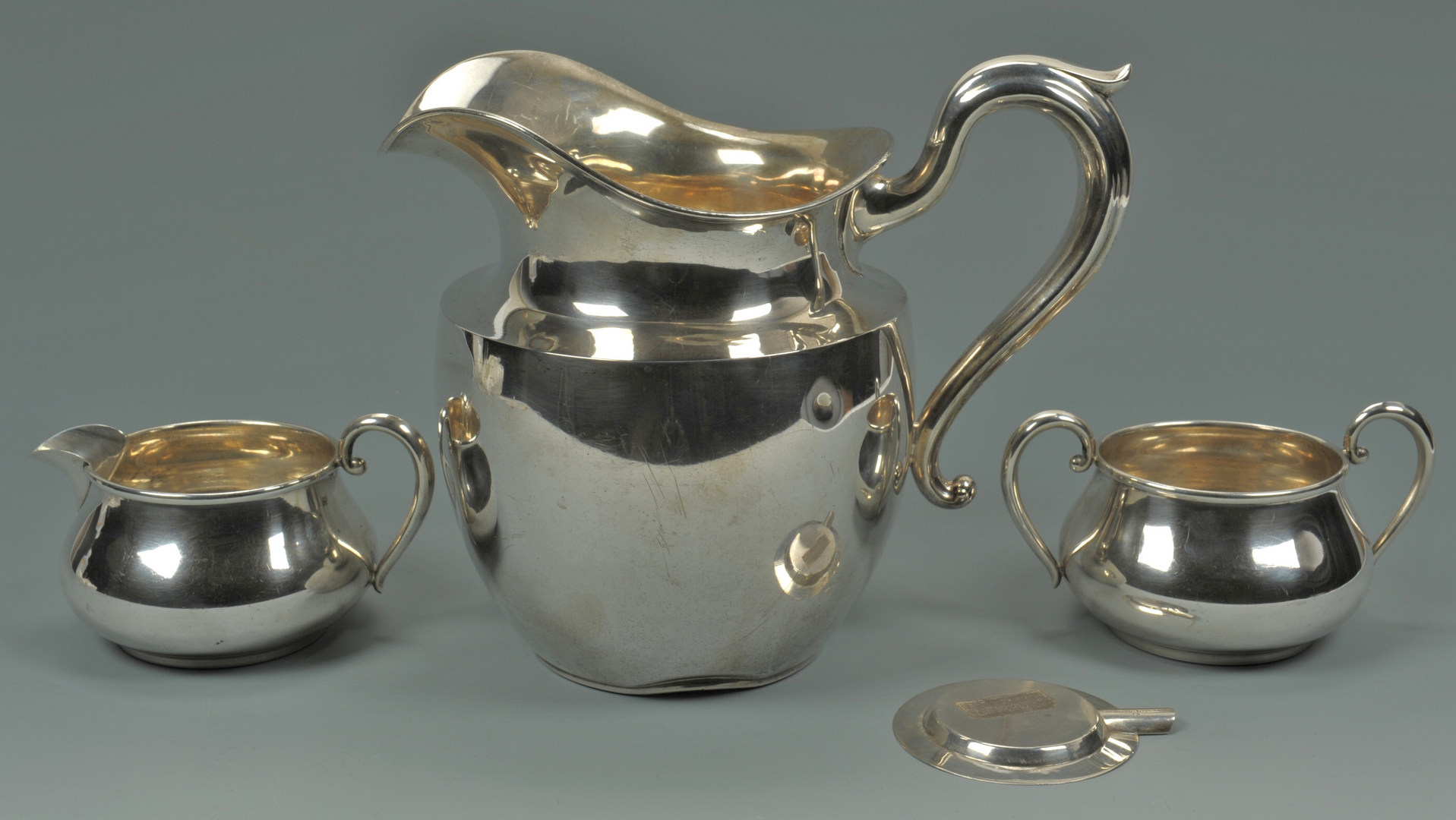 Lot 426: Sterling pitcher, creamer, sugar, small nut bowls