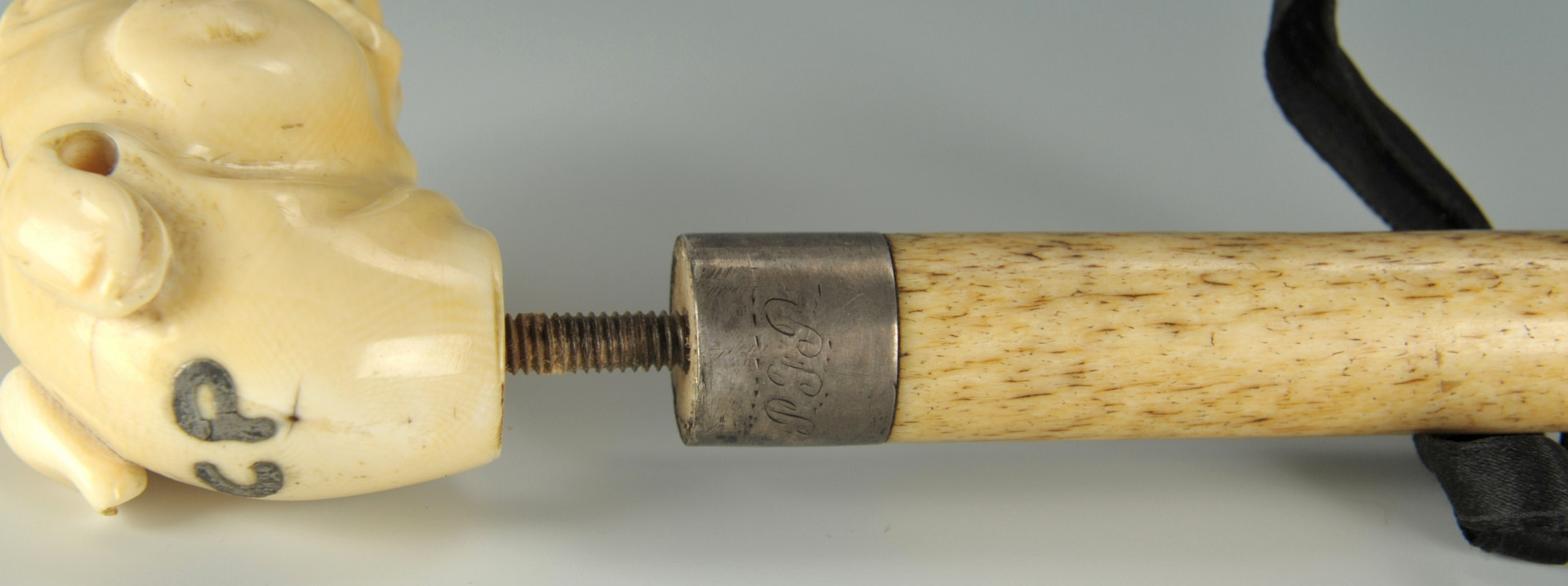 Lot 513: Dog head Ivory handled and bone shaft cane