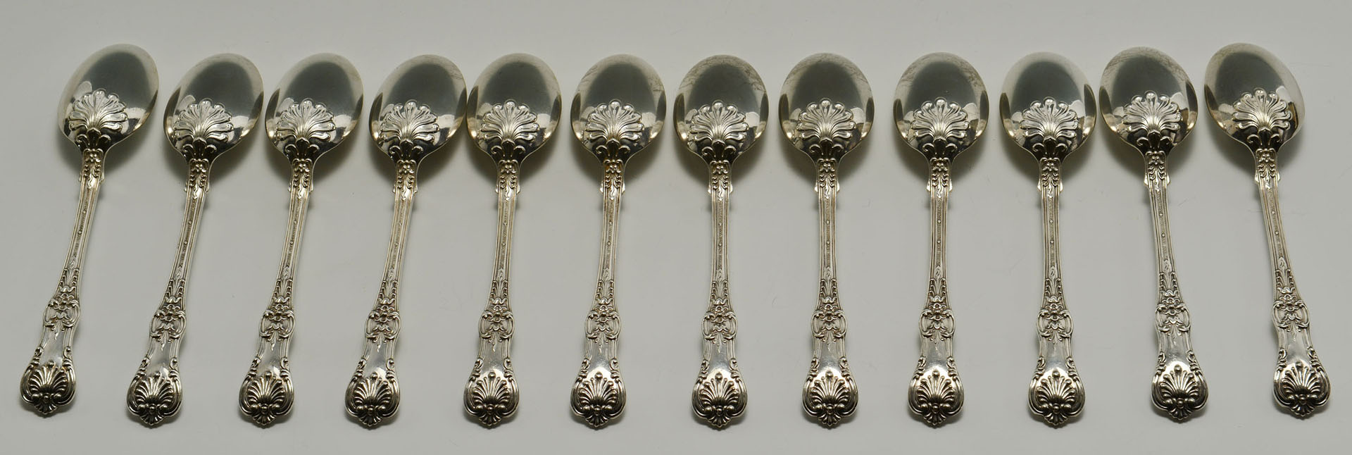 Lot 109: 12 Tiffany English King Sterling Spoons, cased