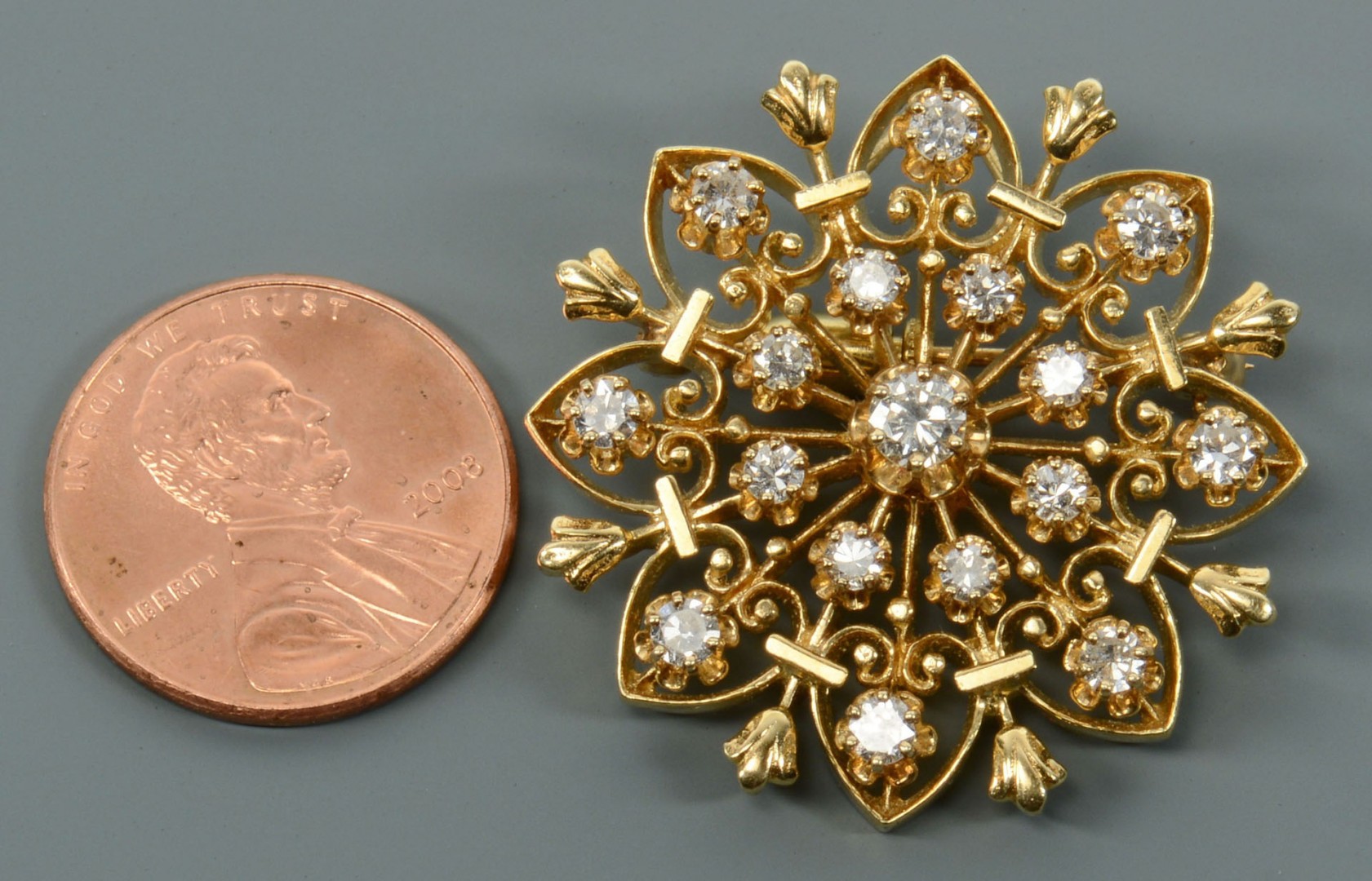 Lot 118: 14k Gold and Diamond Starburst Pin