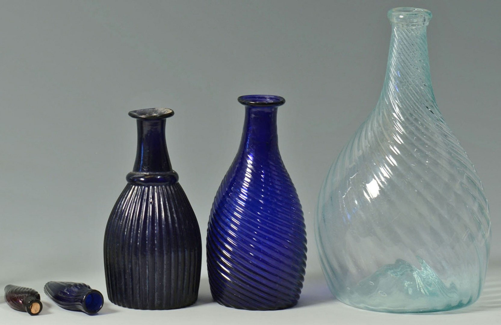 Lot 158: 10 blown colored glass bottles, many pitkin type