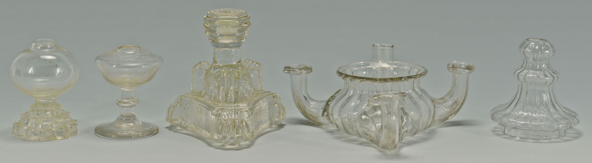 Lot 283: 9 Colorless blown and molded glass oil lamps