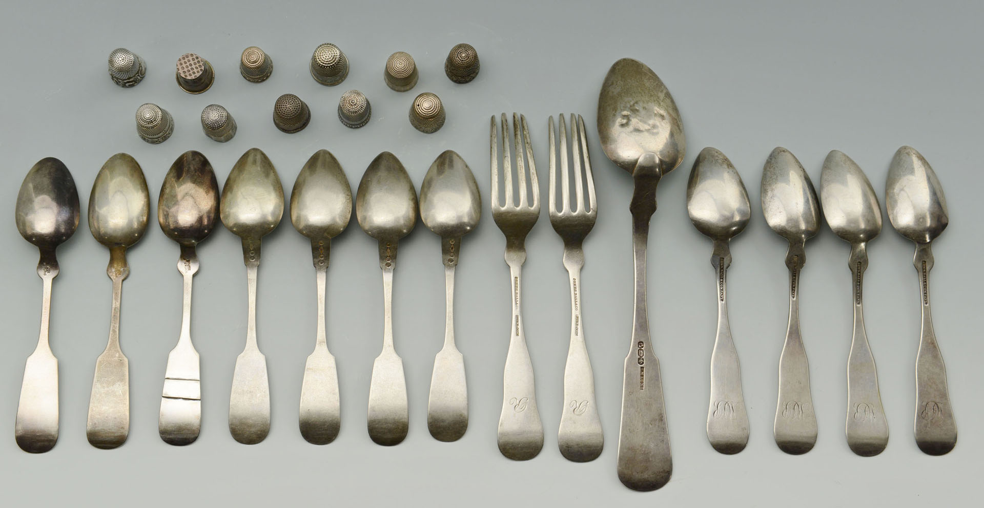 Lot 292: 14 pcs. coin and sterling silver flatware & 11 thi