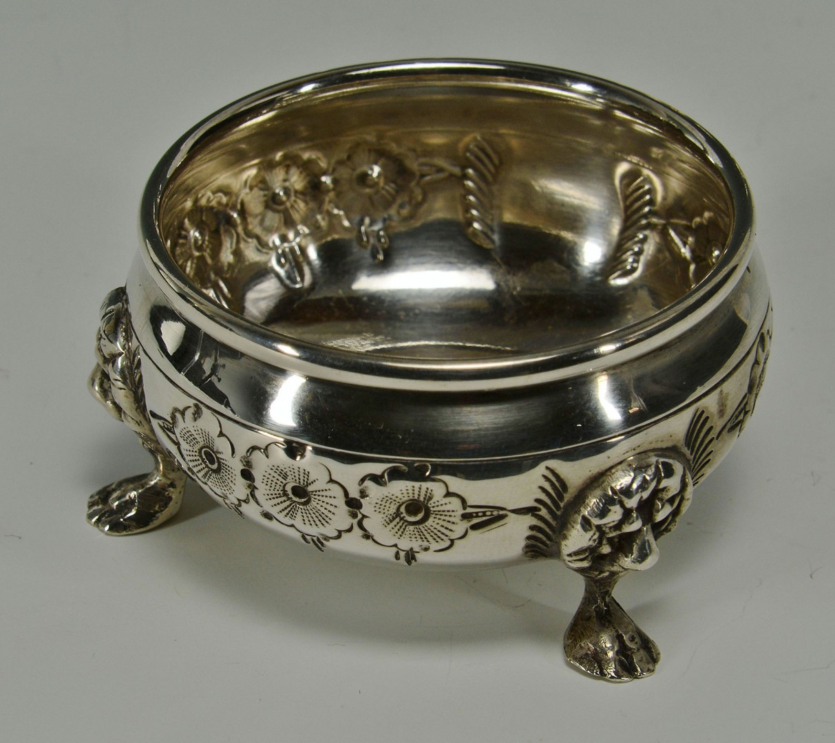 Lot 295: Hand chased sterling silver salts and peppers