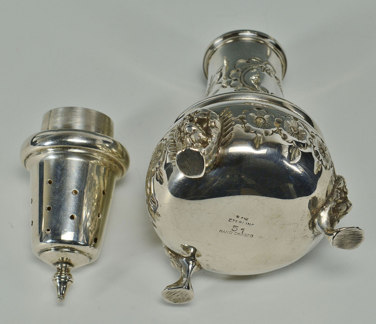 Lot 295: Hand chased sterling silver salts and peppers