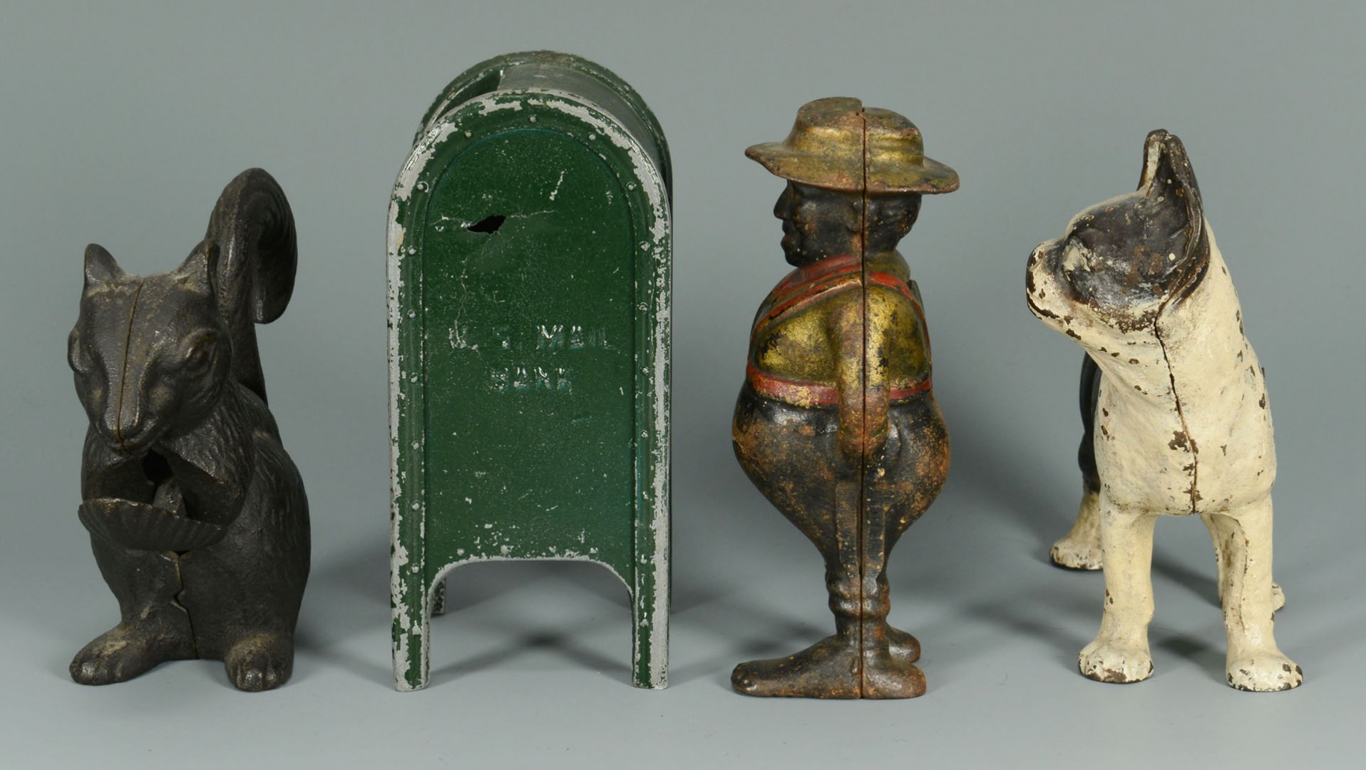 Lot 587: Four cast iron figural items inc. banks
