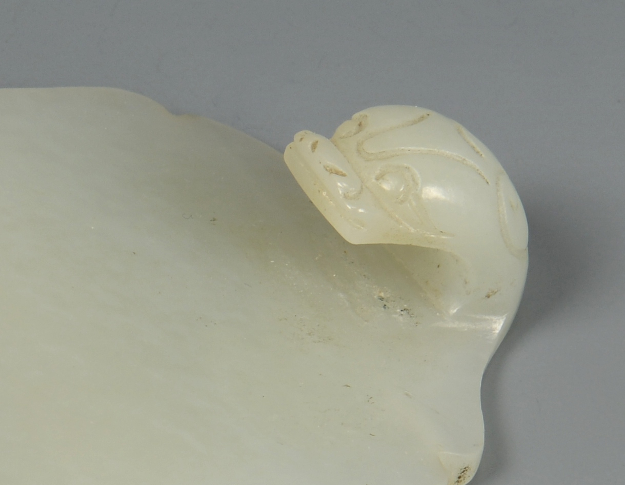 Lot 21: Chinese White Jade Dragon Buckle