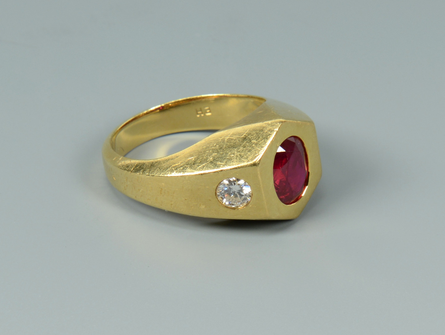 Lot 260: 18k ruby and diamond ring