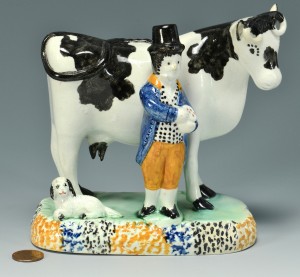 Lot 557: Pearlware figure: Farmer and Cow