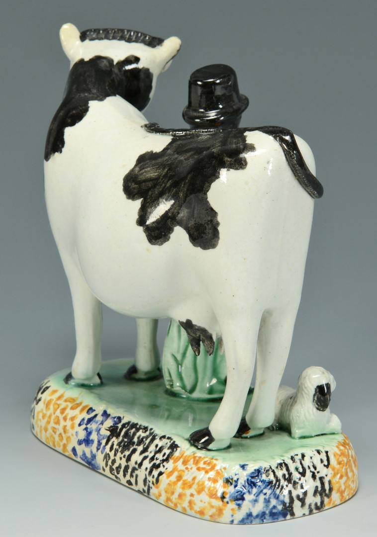 Lot 557: Pearlware figure: Farmer and Cow