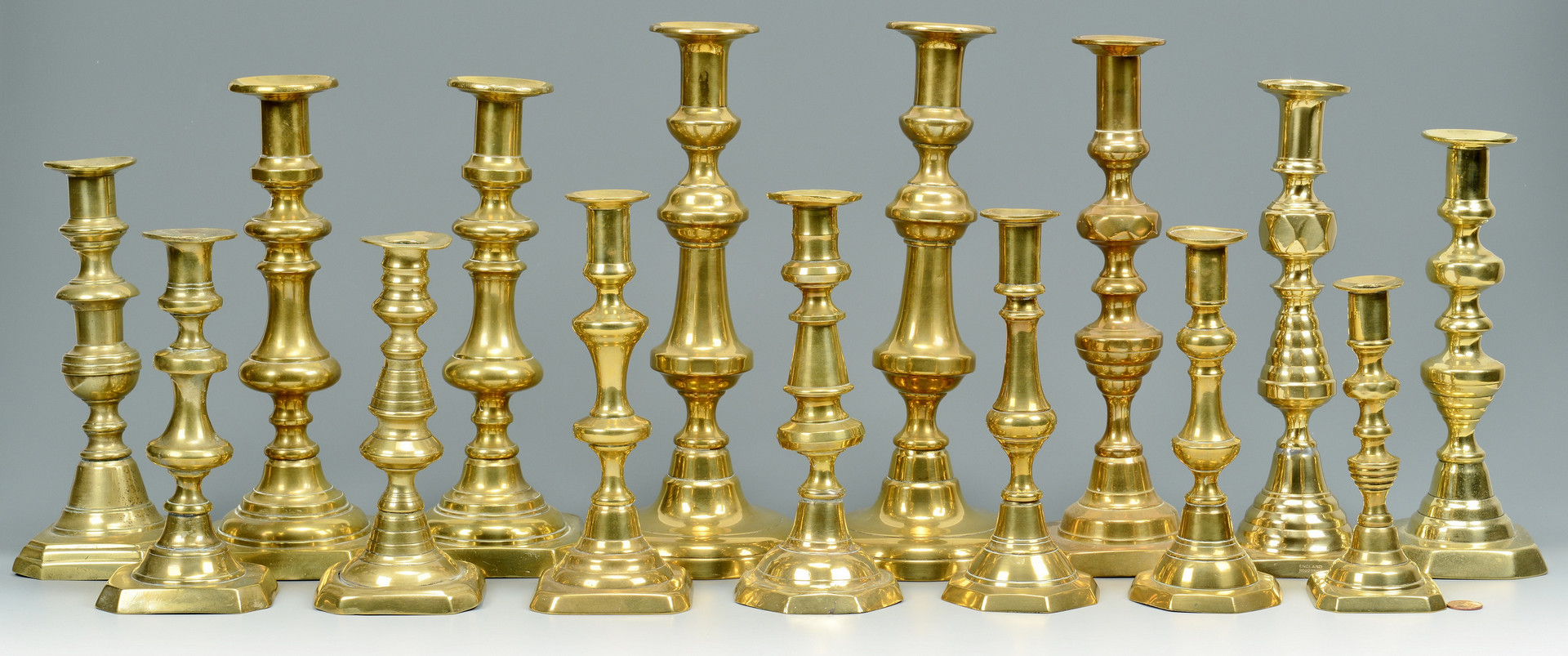 Lot 705: Grouping of Brass Candlesticks, 15 total