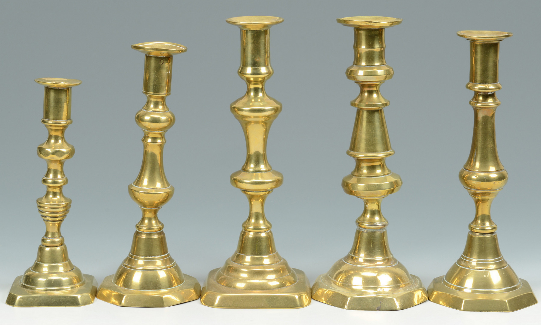Lot 705: Grouping of Brass Candlesticks, 15 total