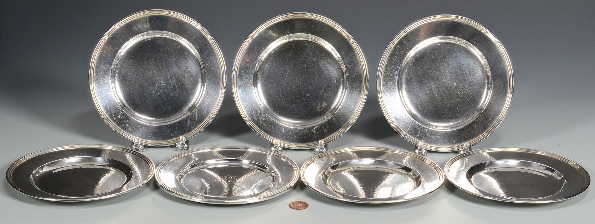 Lot 816: 7 Sterling Bread and Butter Plates