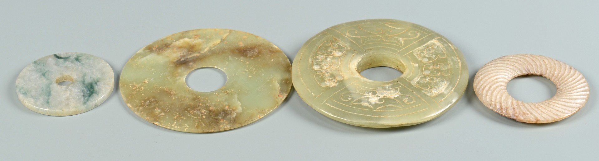 Lot 705: Jade bi discs and axe head, 5 items