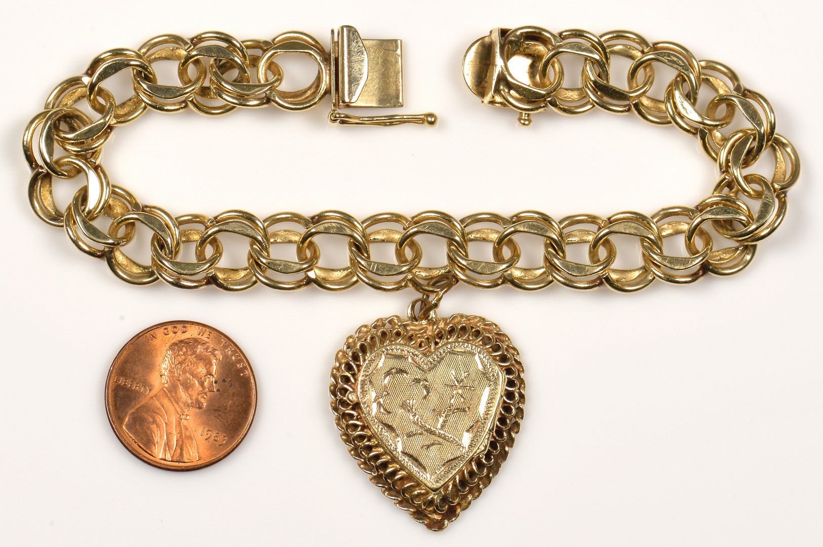 Lot - 14kt Yellow Gold Charm Bracelet with Gold and Gold-Filled Charms +  Baseball Hat Charm + 14kt Pin