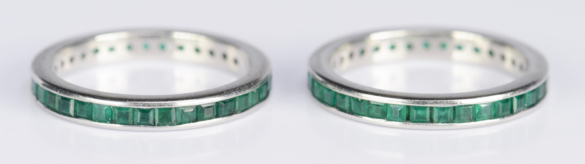 Lot 416: Pair Emerald and Platinum Eternity Rings