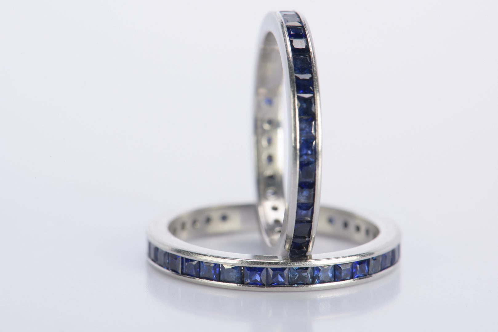 Lot 804: Pair Sapphire and Platinum Eternity Rings