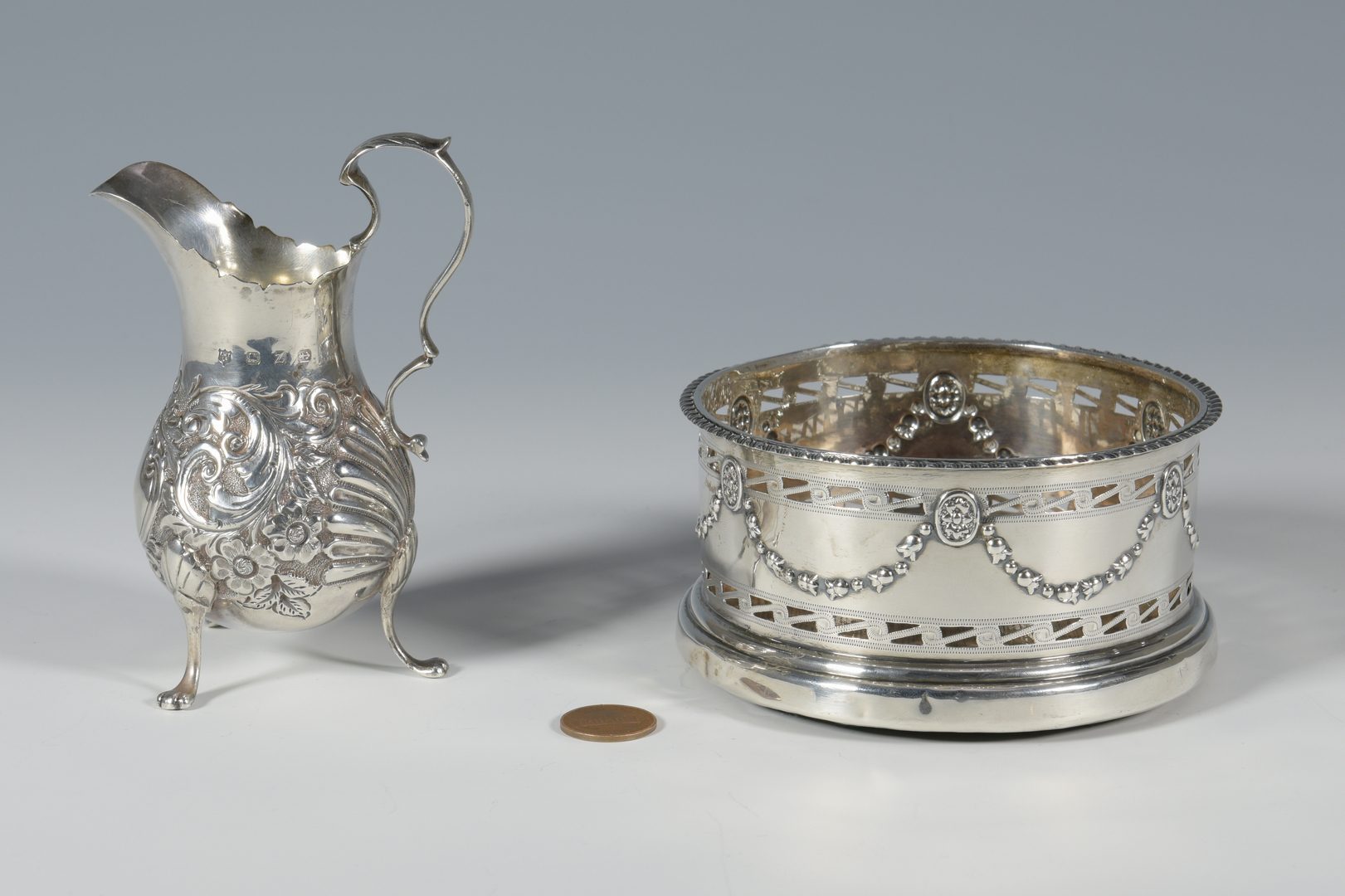 Lot 859: Sterling wine coaster and cream jug
