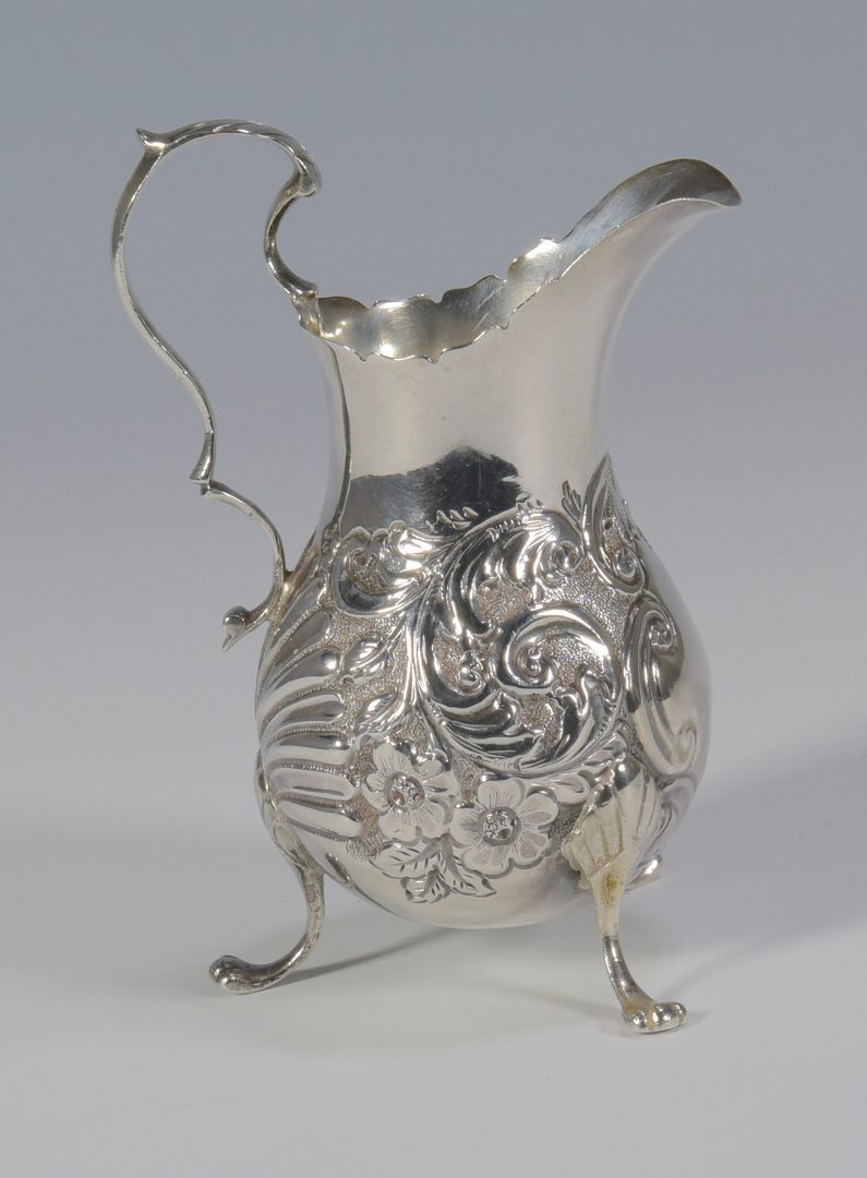 Lot 859: Sterling wine coaster and cream jug