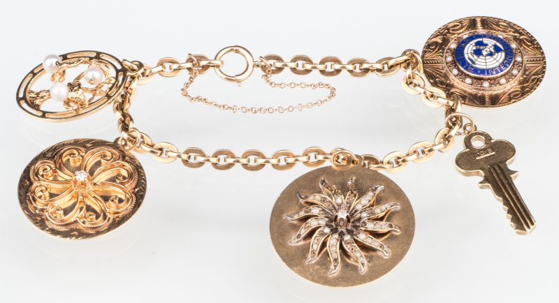 Lot 529: 10K Gold Charm Bracelet, 14K charms