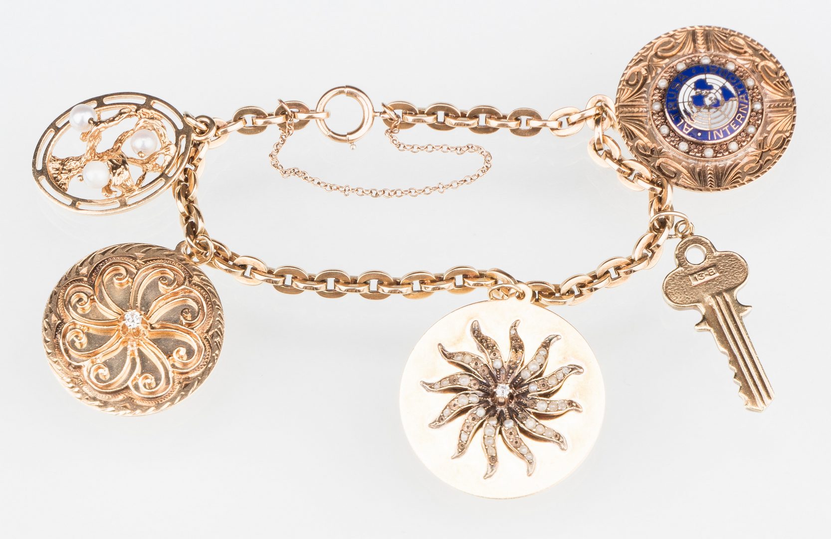 Lot 529: 10K Gold Charm Bracelet, 14K charms | Case Antiques