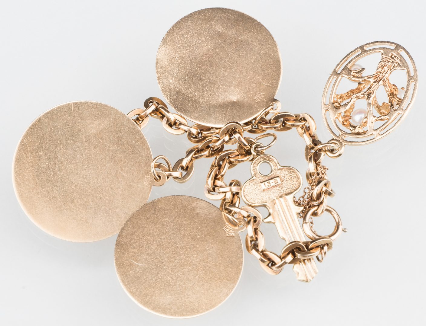 Lot 529: 10K Gold Charm Bracelet, 14K charms