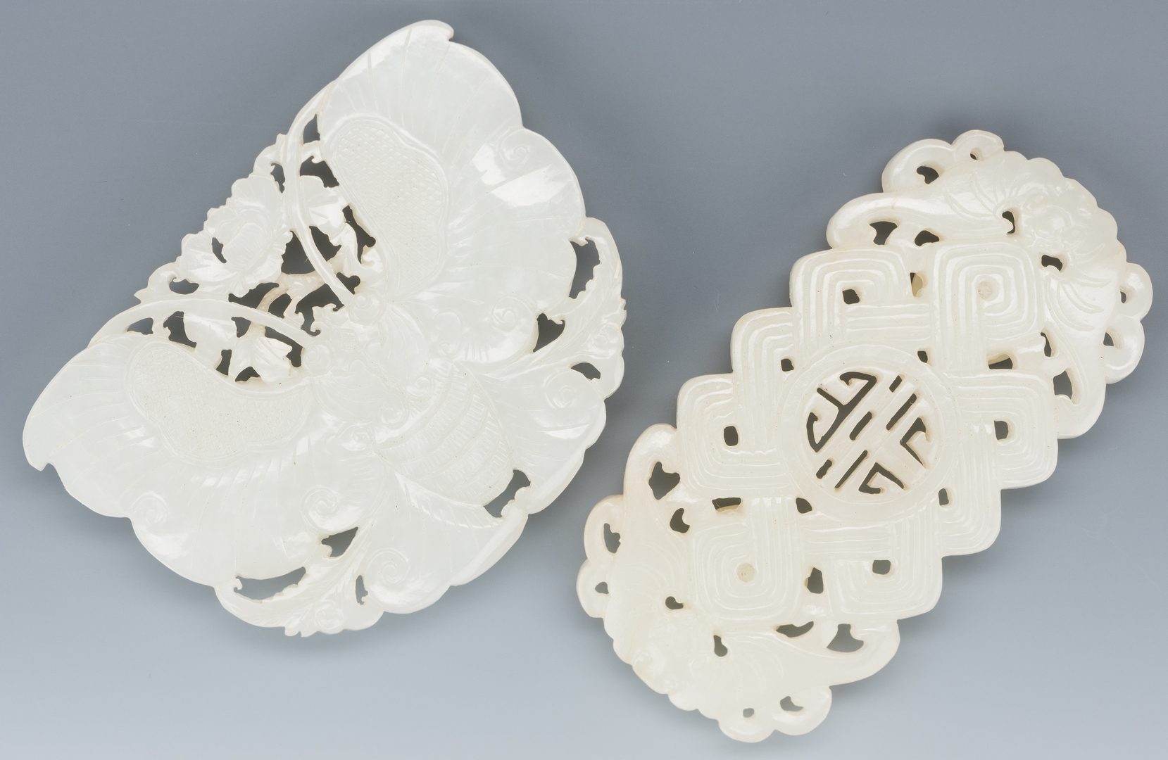 Lot 1: 2 Chinese White/Pale Celadon Carved Belt Buckles