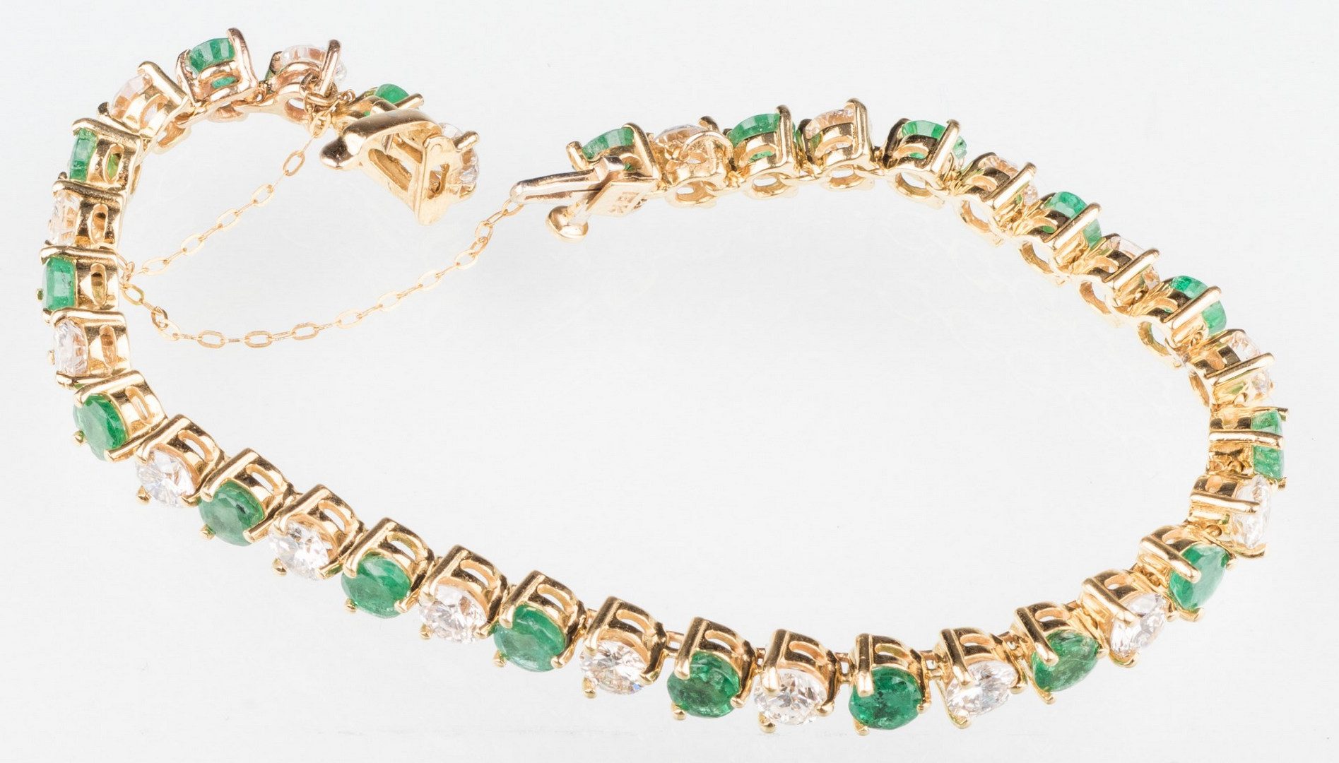 Lot 206: 18K Emerald & Diamond Line Bracelet