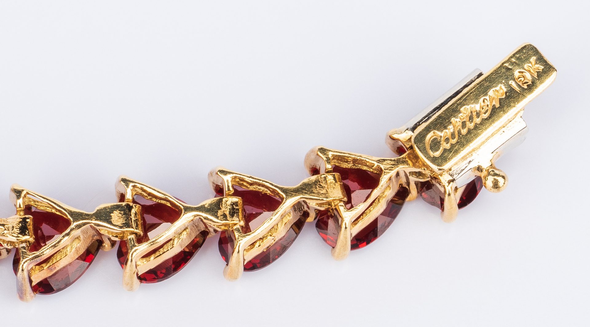 Lot 391: 18K Garnet Bracelet, marked Cartier