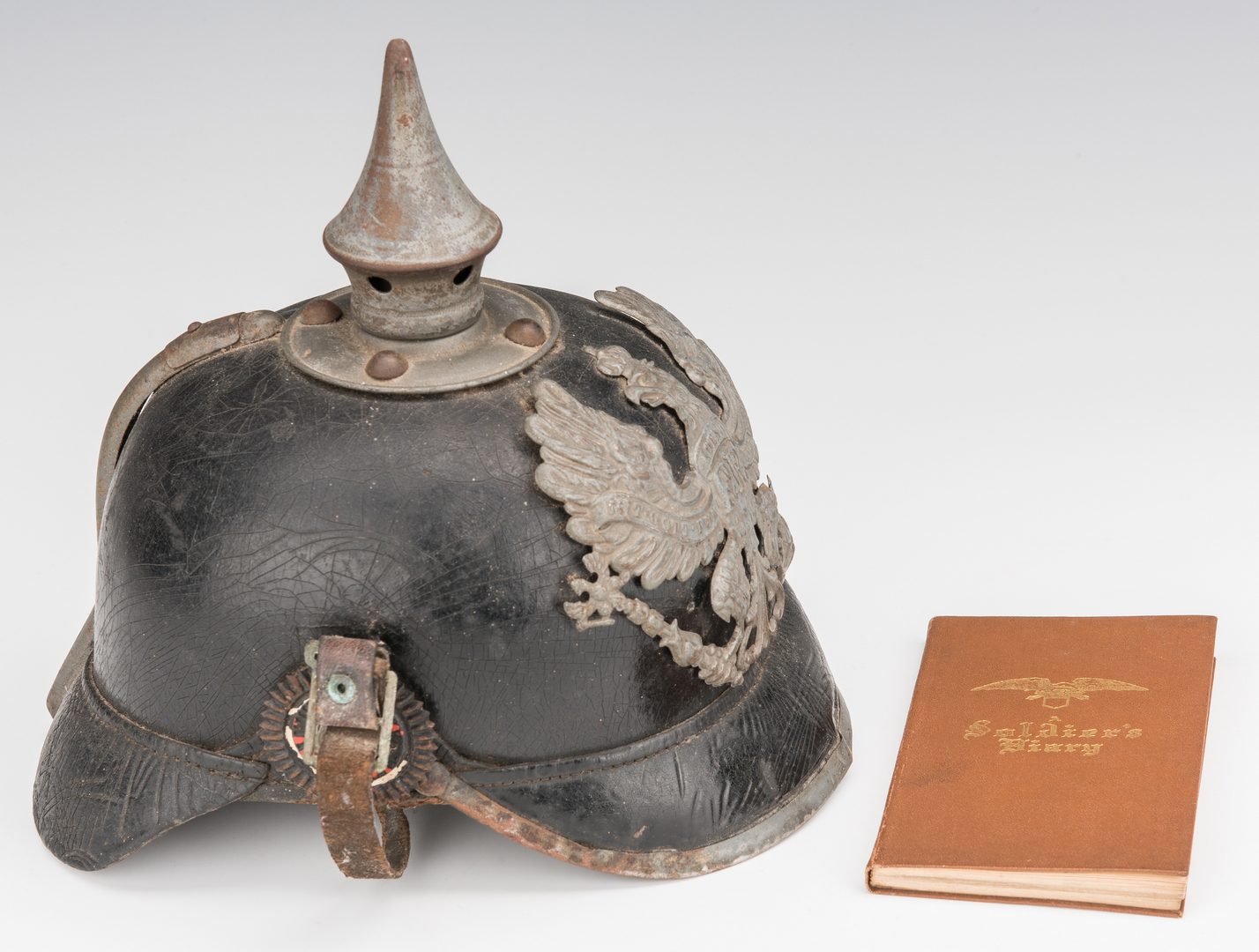 Lot 828: German WWI Pickelhaube Helmet,  WWI autograph book & Glass