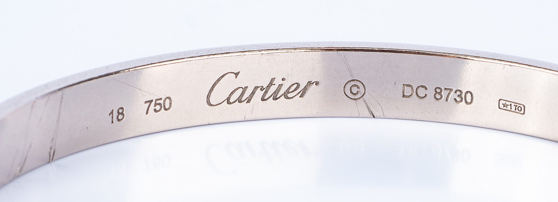 Lot 44: 18K Cartier Love Bangle; 14K Puzzle Ring