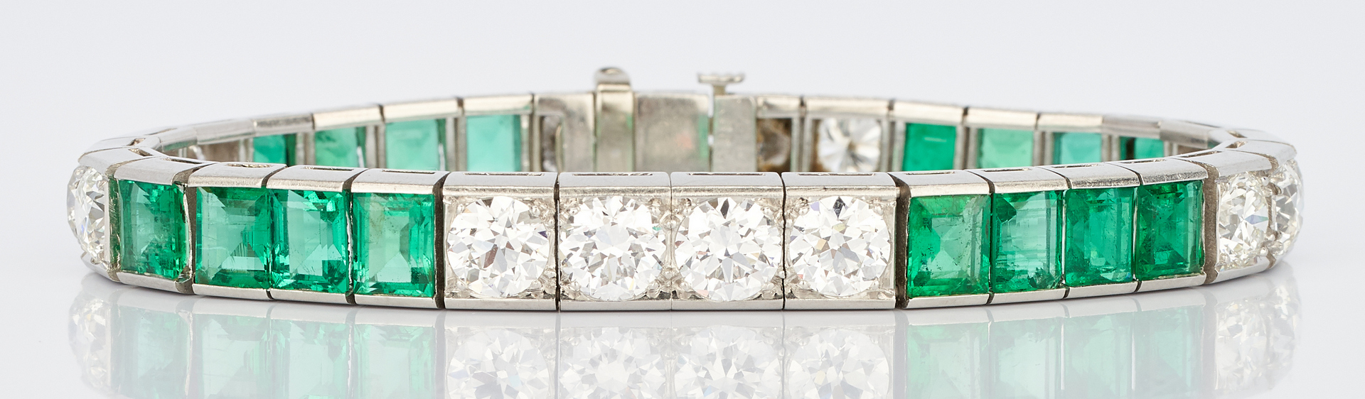 Lot 31: Ladies Platinum Diamond and Emerald Bracelet