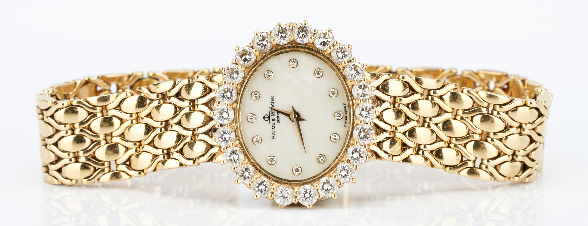 Lot 40: 18K Baume & Mercier watch with Diamond Surround