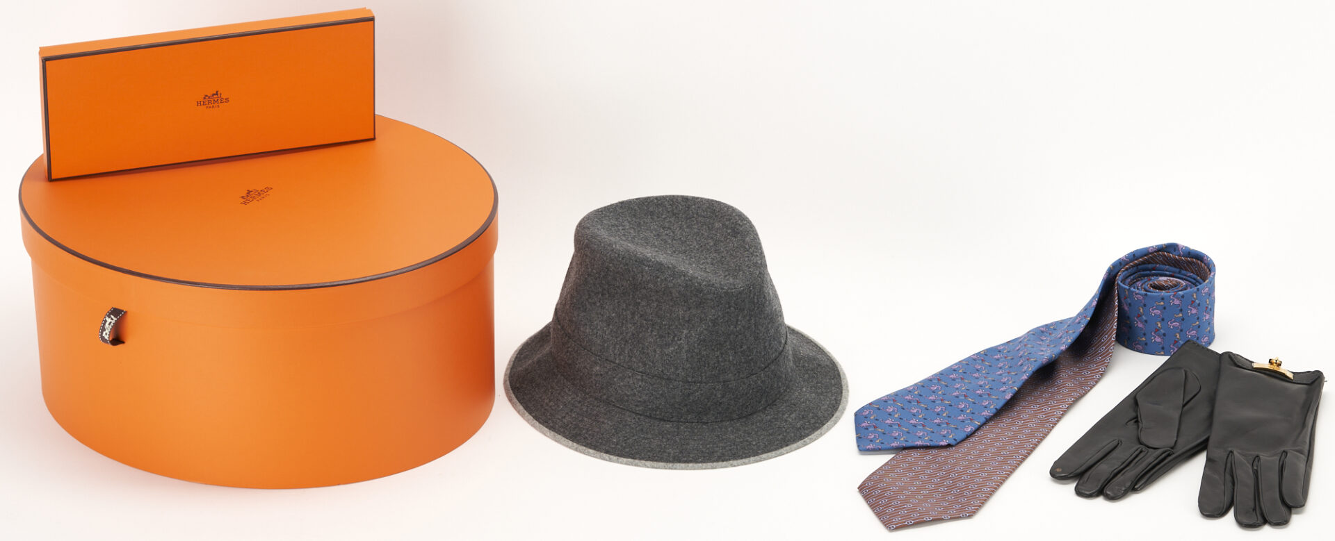 Lot 1172: Hermes Grey Flannel Hat, 2 Silk Print Neckties & Leather Gloves, 4 items