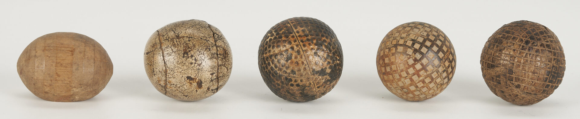 Lot 628: Collection of 5 Antique Golf / Chole Balls, 3 Stands