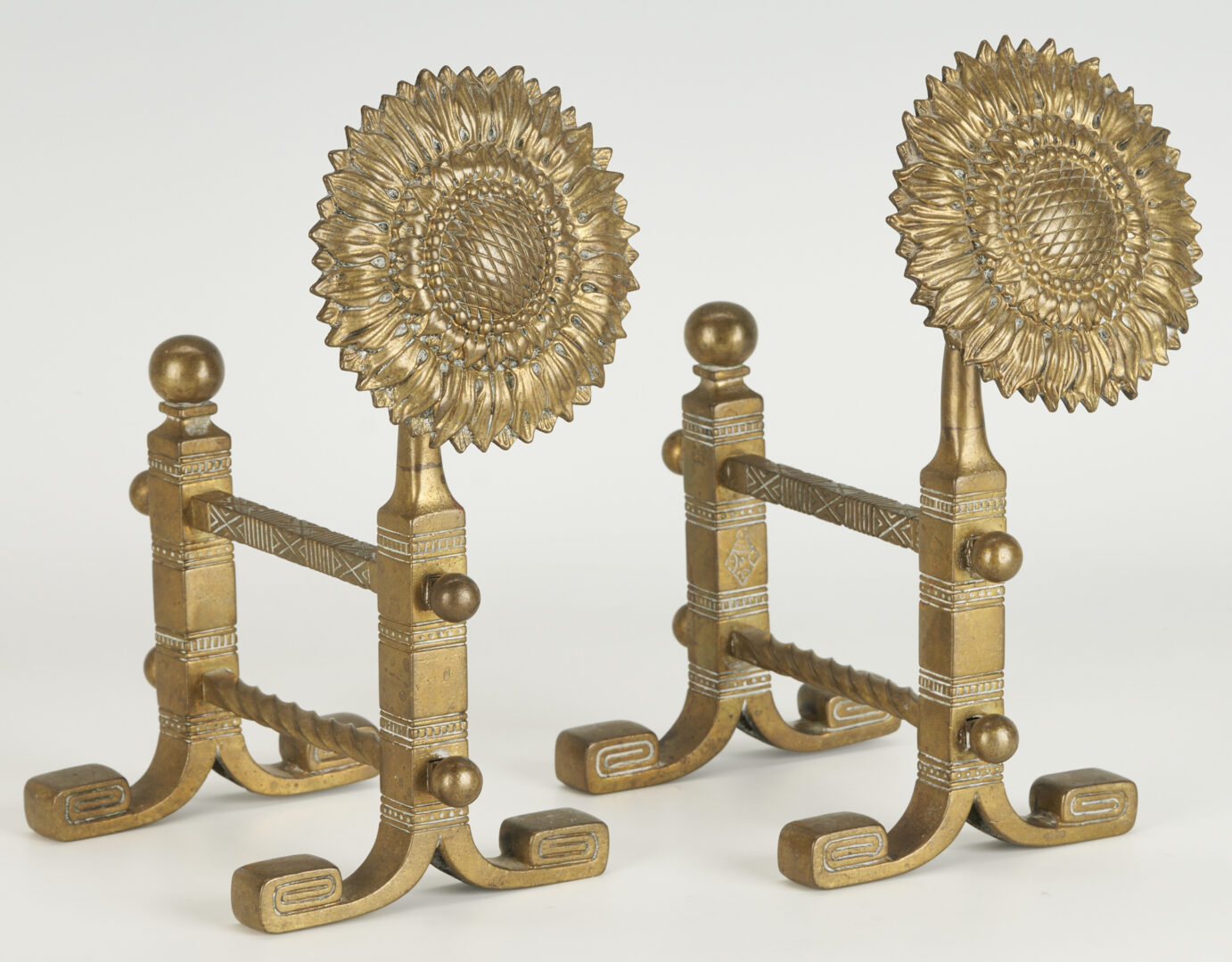 Lot 380: Pair of Aesthetic Movement Sunflower Brass Fire Dogs Tool Rests