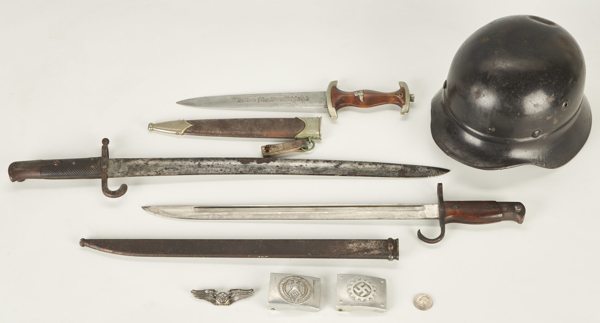 Lot 604: Collection of WWII & WWI Items: Helmet, Dagger, Bayonets & Buckles