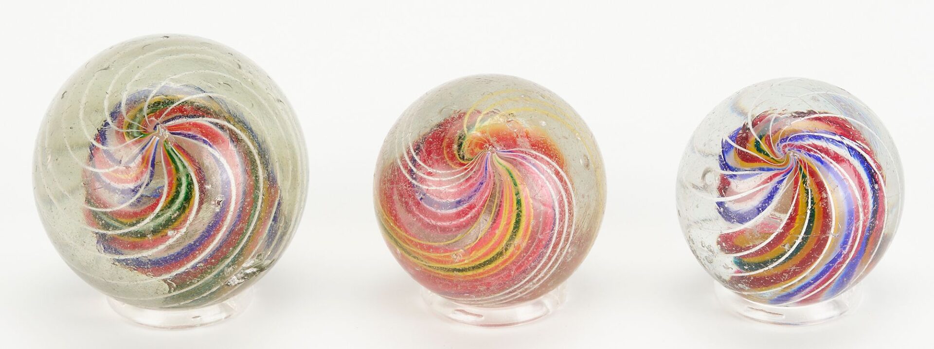 Lot 670: 6 Large Transparent Swirl Marbles, incl. 3-Stage