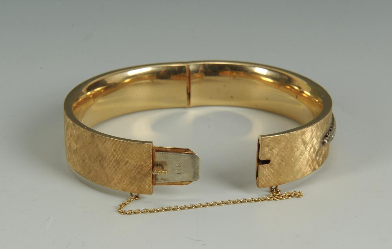 Lot 153: 14K gold and diamond bangle bracelet, 24.9 grams