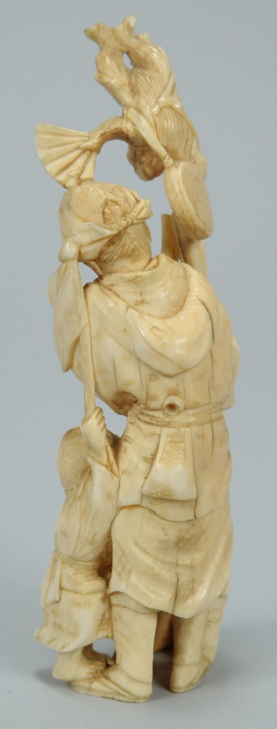 Lot 393: Ivory Okimono figure, man with monkeys